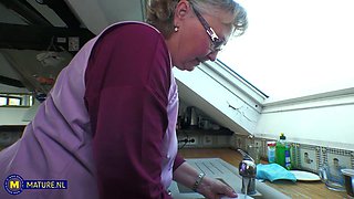 Old mature blonde is giving handjob to lucky dude
