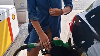 She is refueling at the gas station, showing her tits and pussy