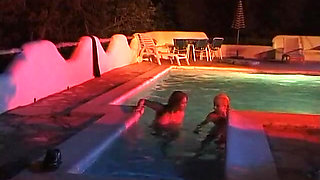 Two sexy lesbian chicks are swimming together in the swimming pool